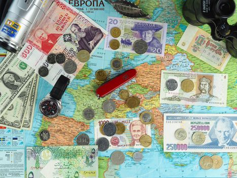 Map of Europe, political or general geology with traveler's items, banknotes and coins of various European countries. High quality photo