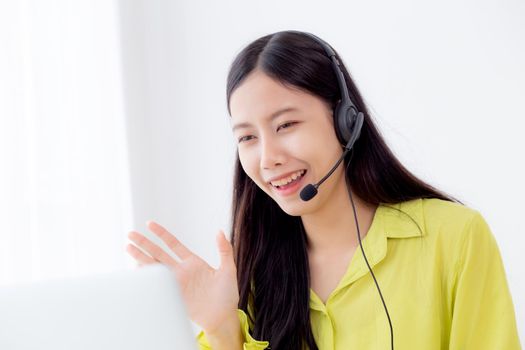 Young asian business woman using laptop computer for video conference online with social distancing, businesswoman working with video call, new normal, communication and work from home concept.