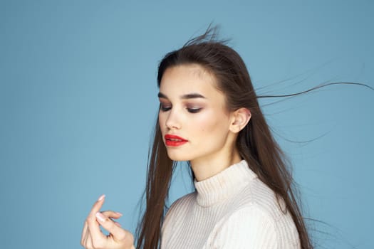 Pretty woman red lips white jacket attractive look close-up blue background. High quality photo