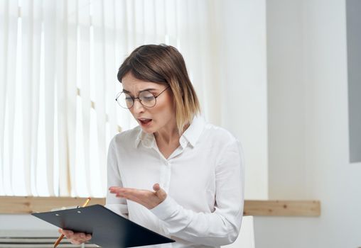 Business woman with a folder of documents in hands stress irritability emotions. High quality photo