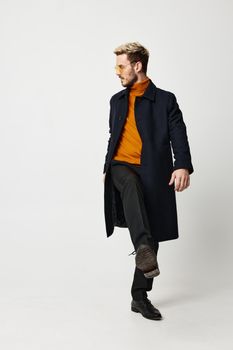 energetic man in orange sweater modern adult man suit coat pant. High quality photo