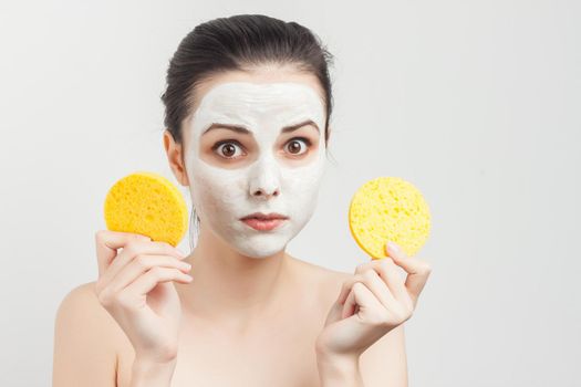 cheerful woman holding sponges in hands removing makeup scrub. High quality photo