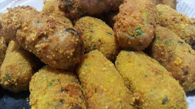 Closeup perspective view of home made spicy and delicious croquettes served with tea or other dishes during parties as fast food.