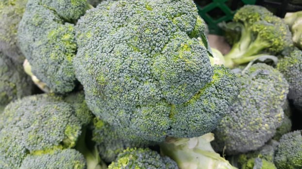 Green fresh broccoli pile placed in market for sale. A Close up top view