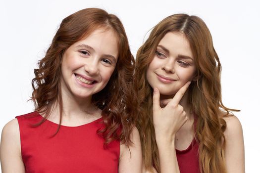 Cheerful mom and daughter hugs joy lifestyle family light background. High quality photo