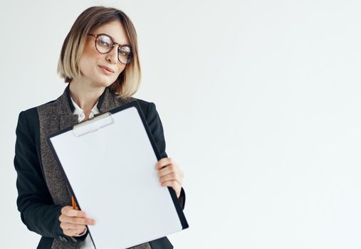 Business woman in a jacket manager model glasses and a white sheet of paper. High quality photo