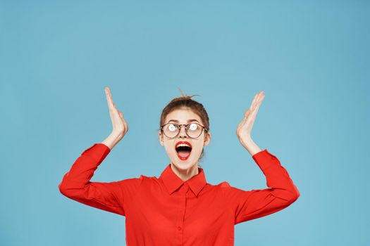 Business woman in red shirt emotions secretary working office blue background. High quality photo
