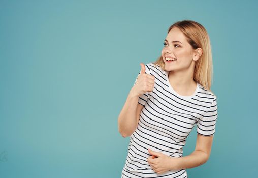 Portrait of a woman in a striped T-shirt on a blue background close-up model Free space Copy Space. High quality photo