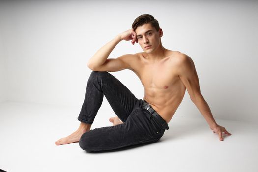 handsome male topless black pants studio model. High quality photo