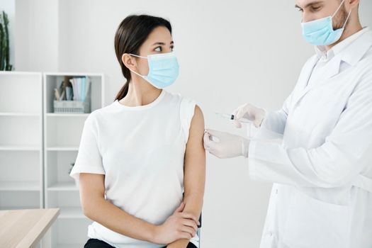 doctor in a medical smear injections to a woman patient from coronavirus. High quality photo