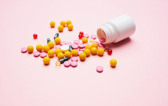 mountain multicolored pills first aid kit packaging pink health background. High quality photo