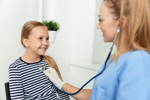 woman doctor examines girl in hospital health procedure. High quality photo