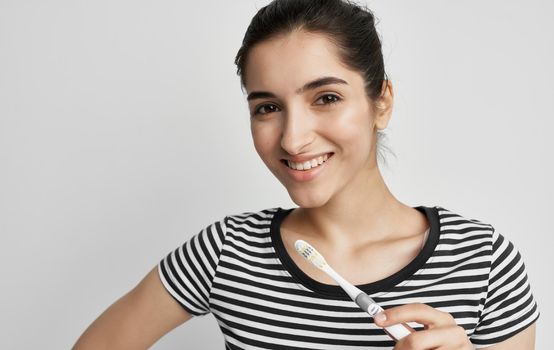 woman in striped t-shirt toothbrush dental health hygiene. High quality photo