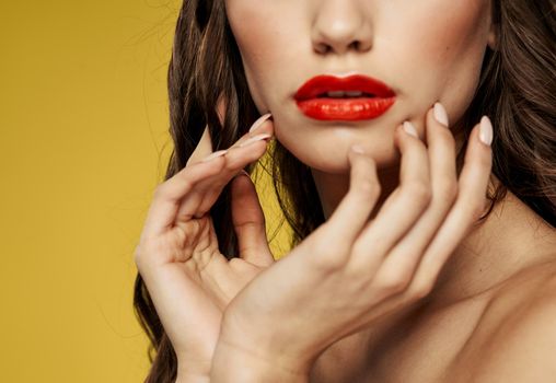 Woman with red lips touches her face with the hands of the Copy Space model. High quality photo