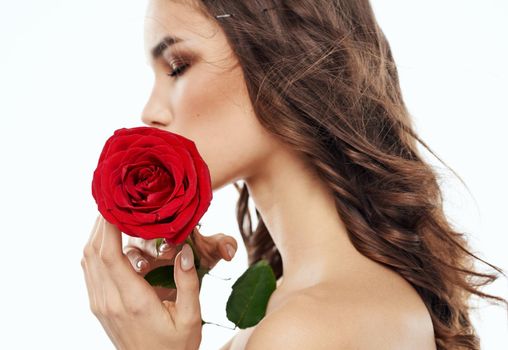 Attractive people with a red flower on the shoulder, naked neck and bright makeup. High quality photo