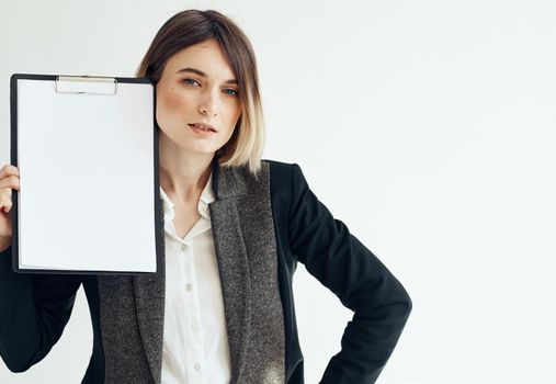 Beautiful woman in jacket with dad documents white sheet of paper mockup. High quality photo