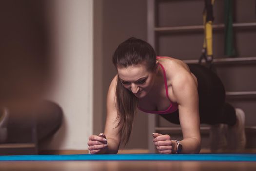 plank position in fitness. young woman exercises.