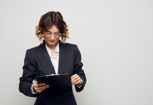 Business woman with folder of documents classic suit glasses finance. High quality photo
