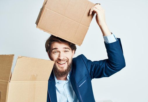 A man with boxes while a suit is moving unpacking. High quality photo