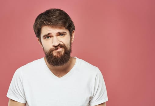 man grimacing on pink background cropped view Copy Space. High quality photo