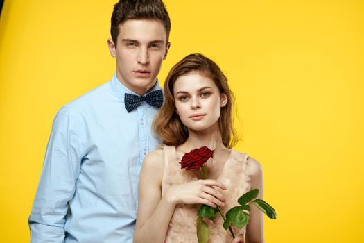 Young couple rose date glamor luxury yellow background. High quality photo