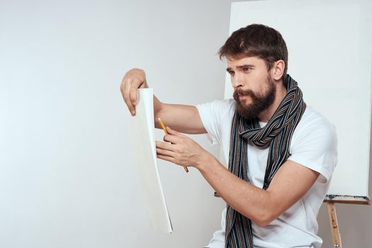Man in white t-shirt artist drawing creativity work. High quality photo