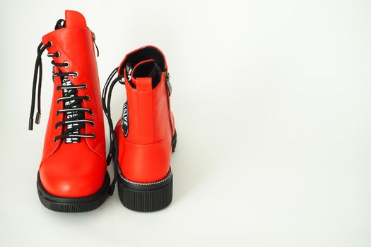 Fashionable women's shoes are red, with zipper and lacing, insulated on a white background. High quality photo