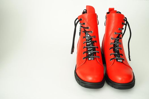 Fashionable women's shoes are red, with zipper and lacing, insulated on a white background. High quality photo