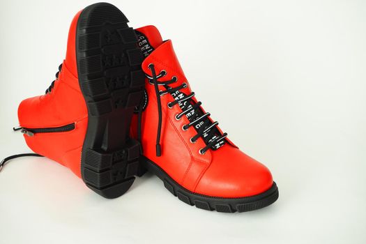 Fashionable women's shoes are red, with zipper and lacing, insulated on a white background. High quality photo