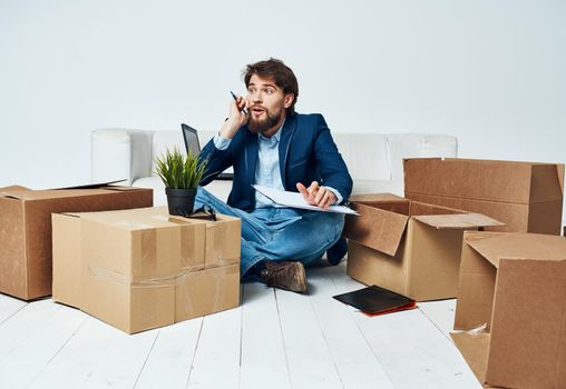 Man talking on the phone boxes with things moving official lifestyle. High quality photo