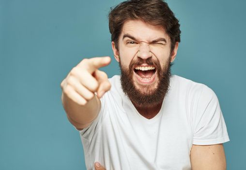 joyful man touching his head with his hands happiness emotions blue background. High quality photo
