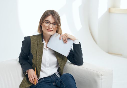 Work office woman model on the couch and papers in hand. High quality photo