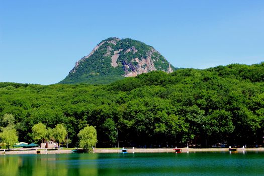 Decorative lake in the park near the mountain.