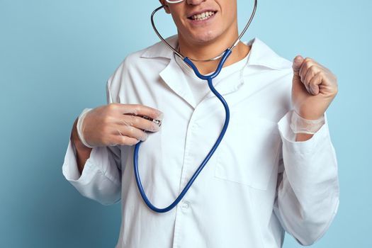 Male doctor white coat treatment medical instruments blue background. High quality photo