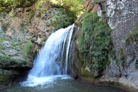 Mountain waterfall in the mountains of the North Caucasus. A high-quality photo.