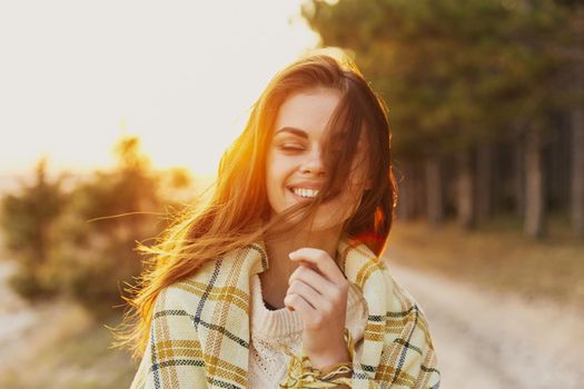 Woman at sunset coniferous forest checkered plaid model. High quality photo