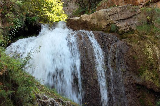 Mountain waterfall in the mountains of the North Caucasus. A high-quality photo.