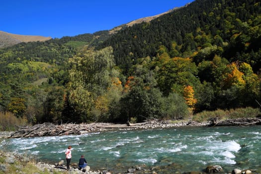 Natural landscape. A mountain river with mountains in the background.