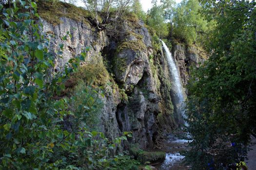 Mountain waterfall in the mountains of the North Caucasus. A high-quality photo.