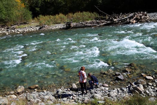 Natural landscape. A mountain river with mountains in the background.