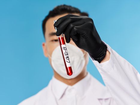 laboratory assistant asian looking medical mask analyzes examination science blue background. High quality photo