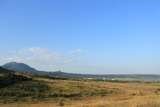 Summer natural landscape with mountains in the background.