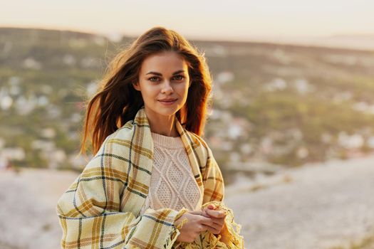 Red-haired woman with fred on nature in the mountains smiling model. High quality photo