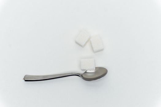 sugar cubes per teaspoon calories sweets light background. High quality photo