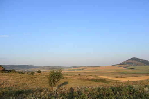 Summer natural landscape with mountains in the background.