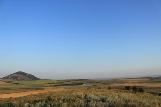 Summer natural landscape with mountains in the background.