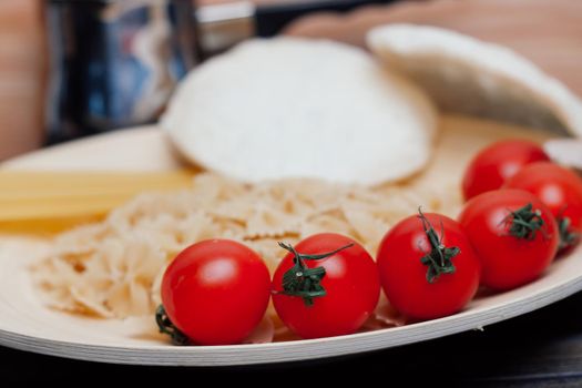 ingredients for making italian pasta cherry tomatoes sauce kitchen. High quality photo