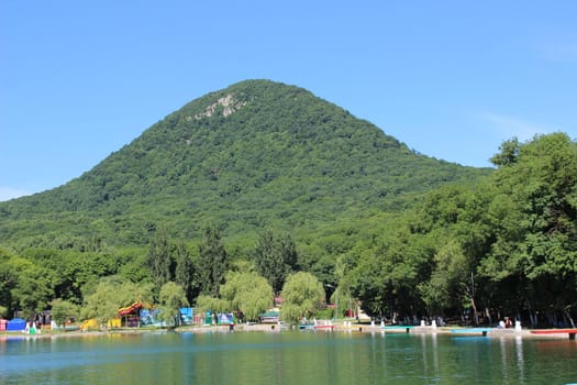 Decorative lake in the park near the mountain.