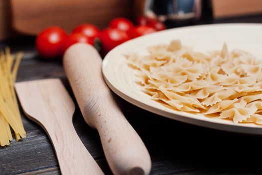 italian pasta on a wooden table cherry tomatoes cooking. High quality photo