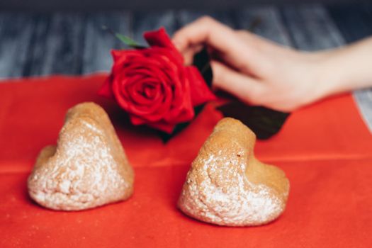 heart-shaped cookies on a red napkin rose flower snack. High quality photo